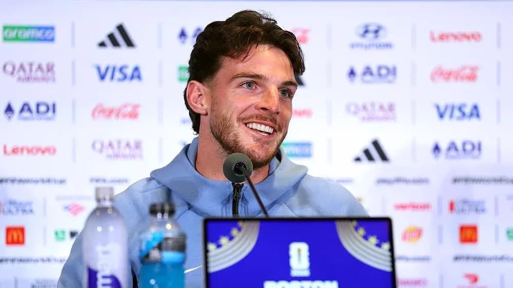 Player speaking at press conference with sponsors' logos