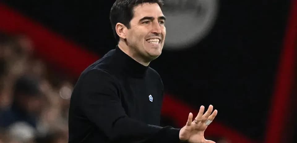 Coach gesturing during a football match on the sidelines