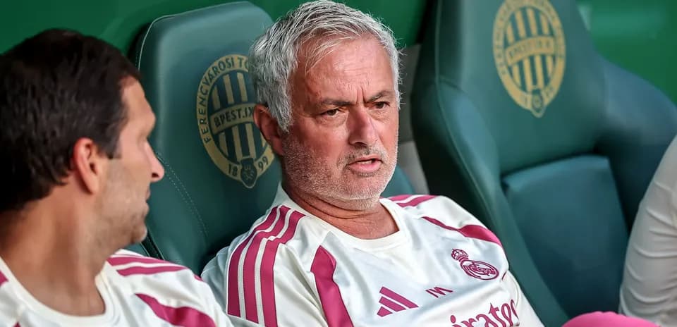 Manager discussing tactics on bench during match