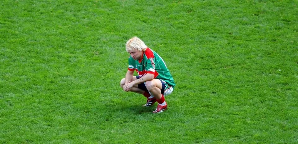 Player squatting on the grass during a match