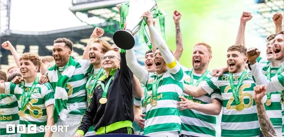 Celtic players celebrating with trophy and medals