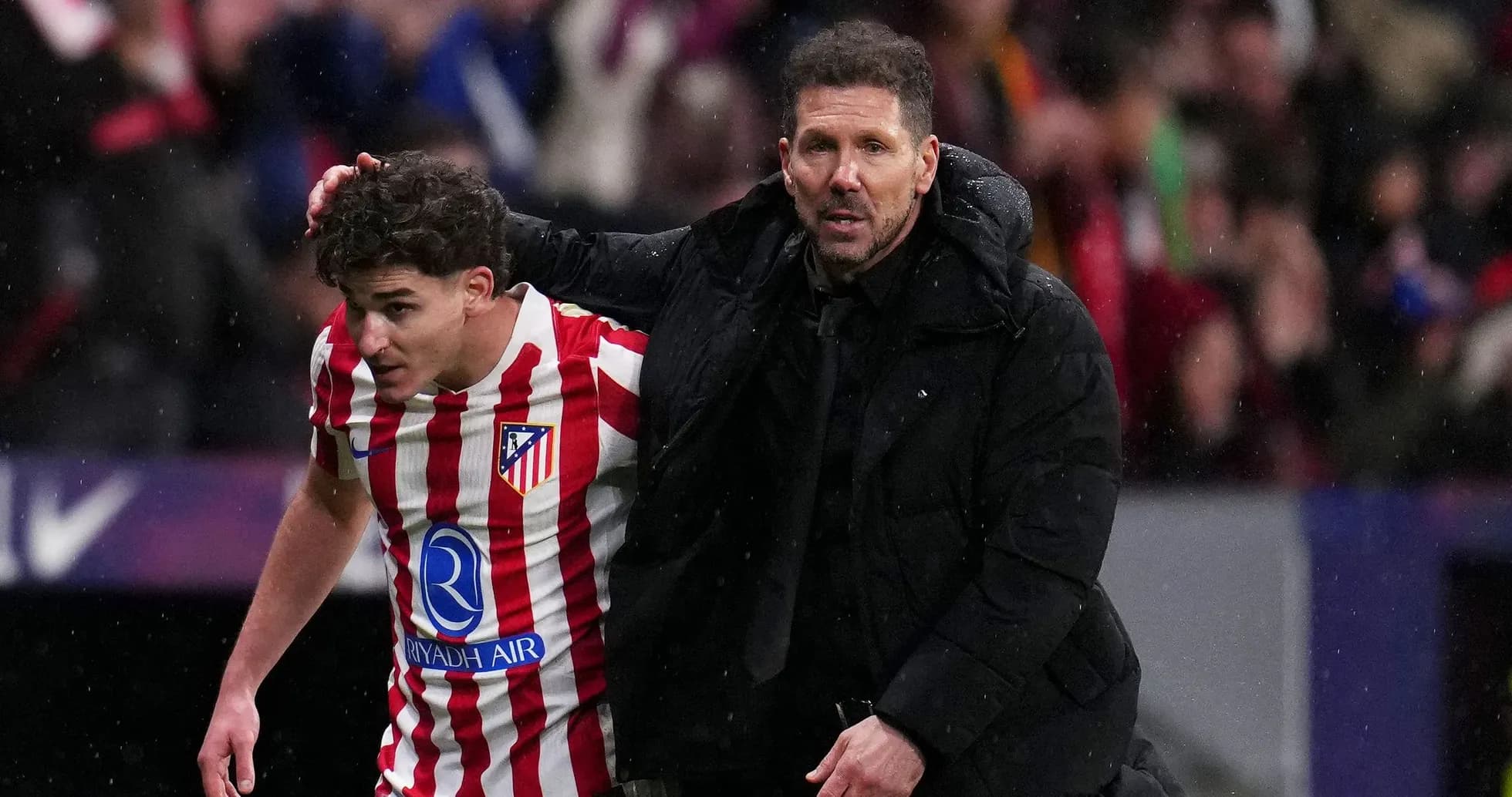 Coach assisting player off the field during match