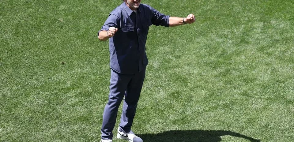 Coach celebrating on the field during training session