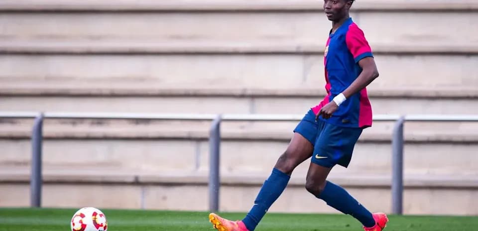 Player in FC Barcelona kit controlling a soccer ball