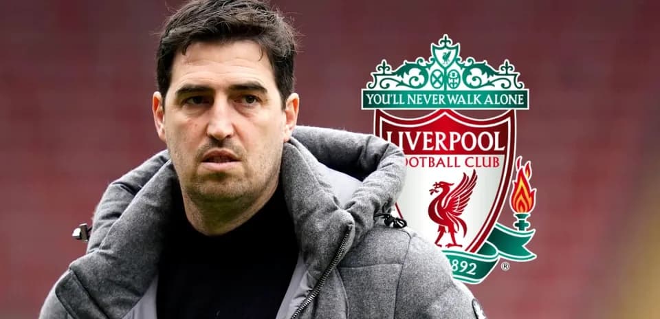 Man in coat with Liverpool FC logo background