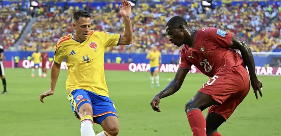 Colombian and Moroccan players challenging for the ball
