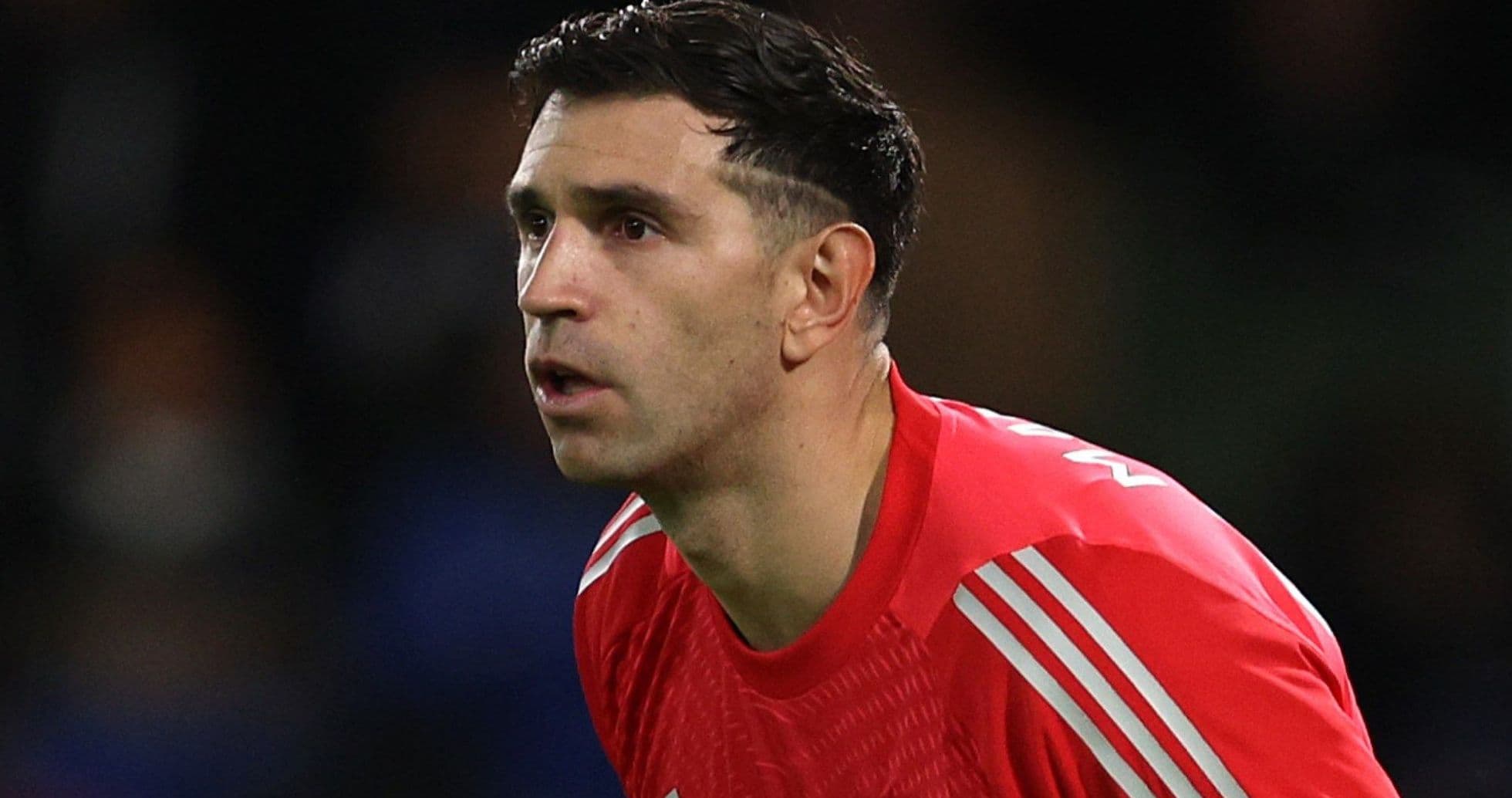 Goalkeeper in red jersey during match action