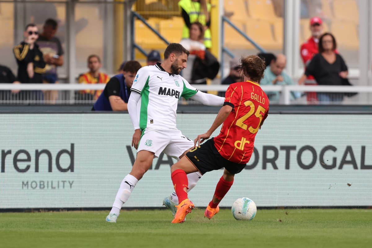 Sassuolo player tackling Lecce opponent