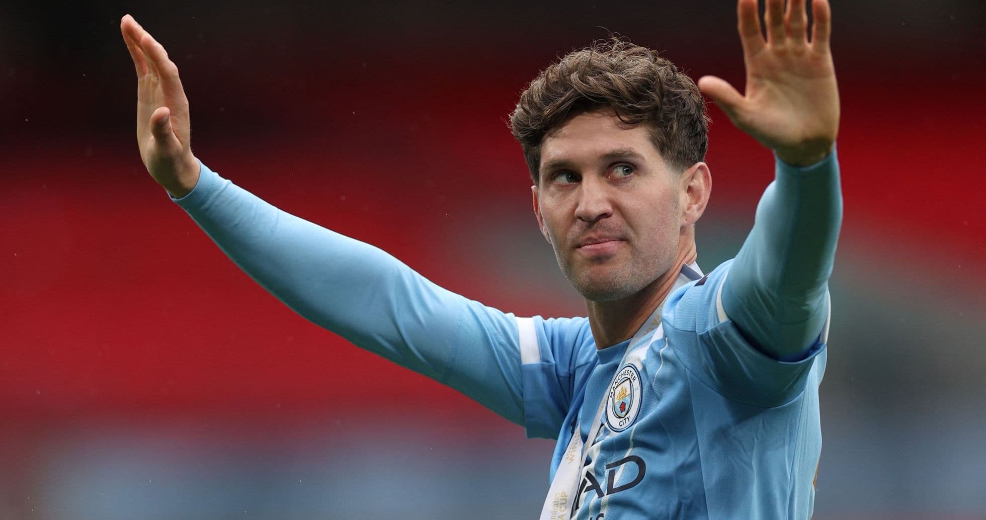 Player gesturing to fans in Manchester City kit