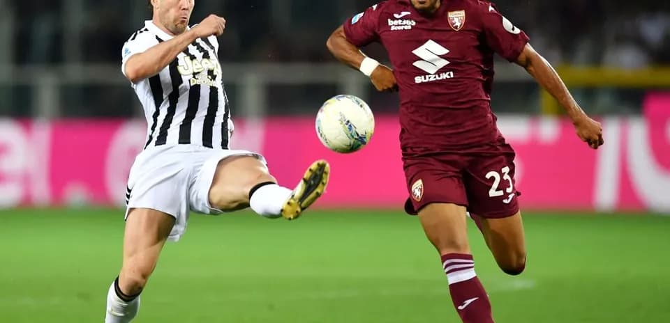 Player from Juventus kicking the ball against Torino