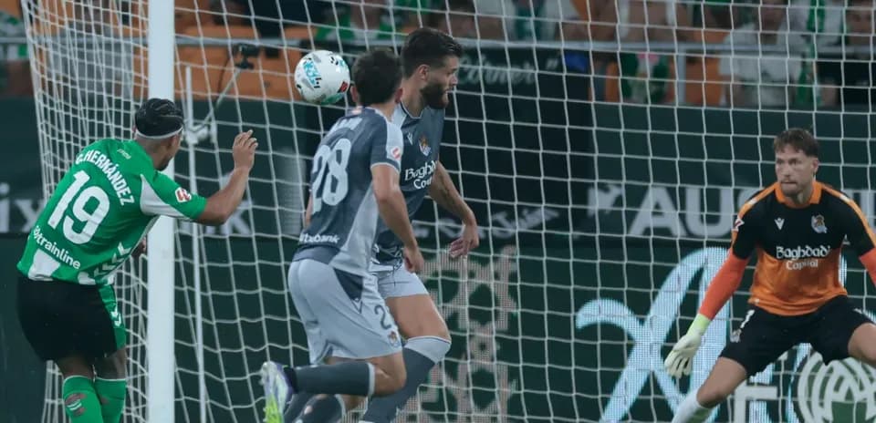 Goalkeeper preparing for a header during match
