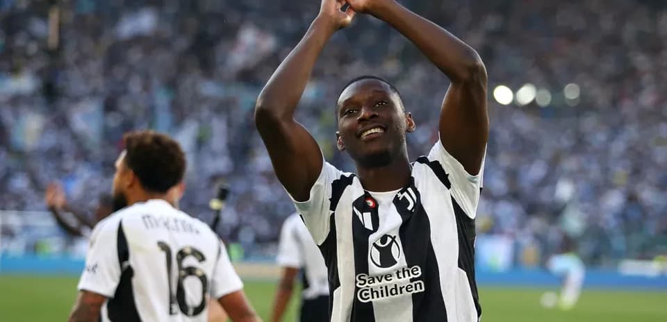 Player celebrating with fans after scoring a goal