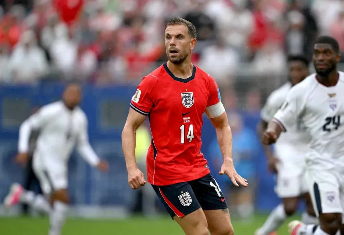 Player in red England jersey during match action