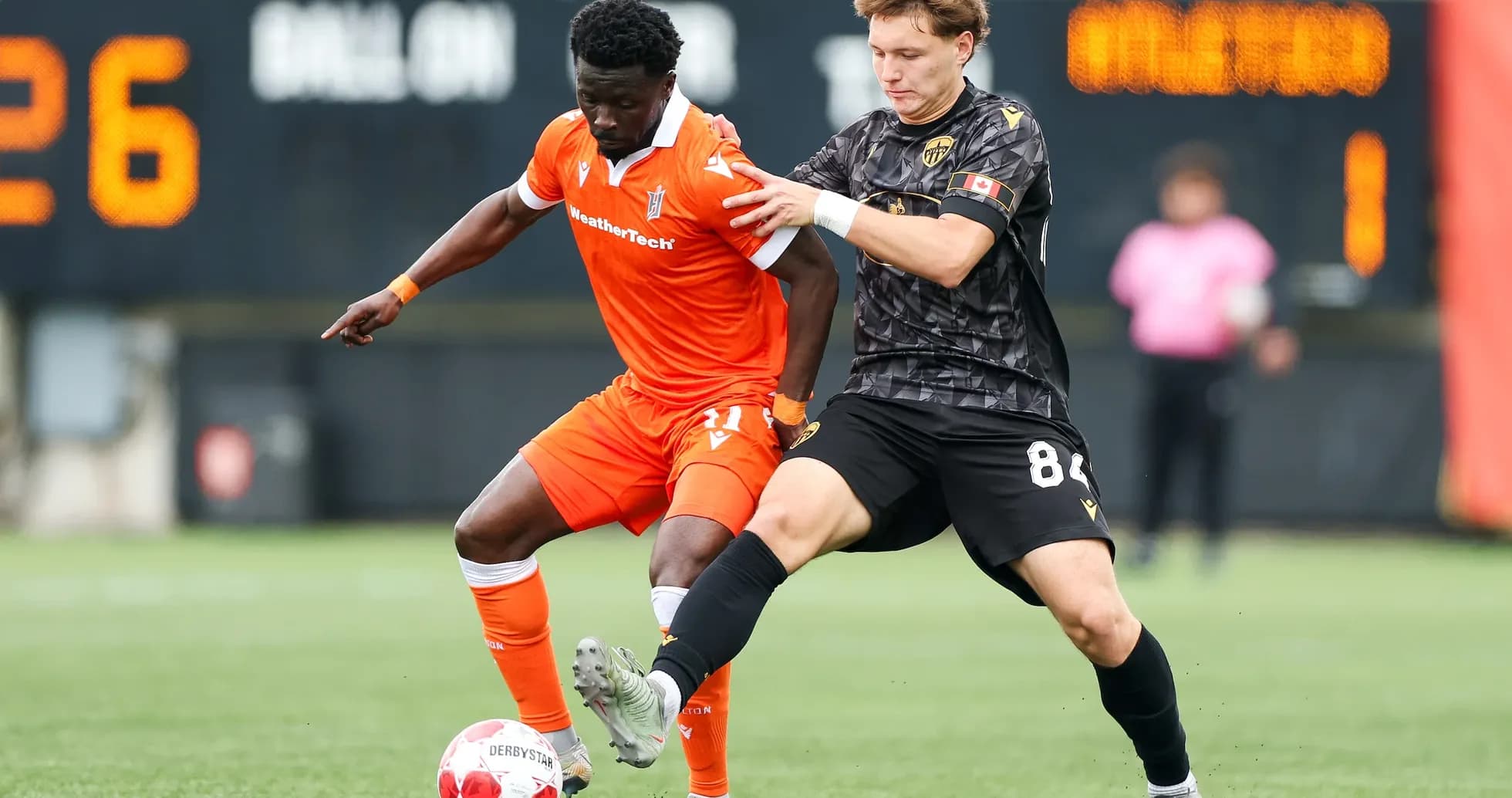 Two players competing for the ball in match