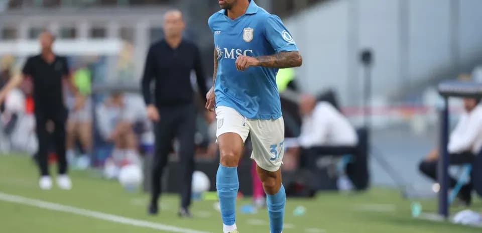 Player in blue jersey running with soccer ball