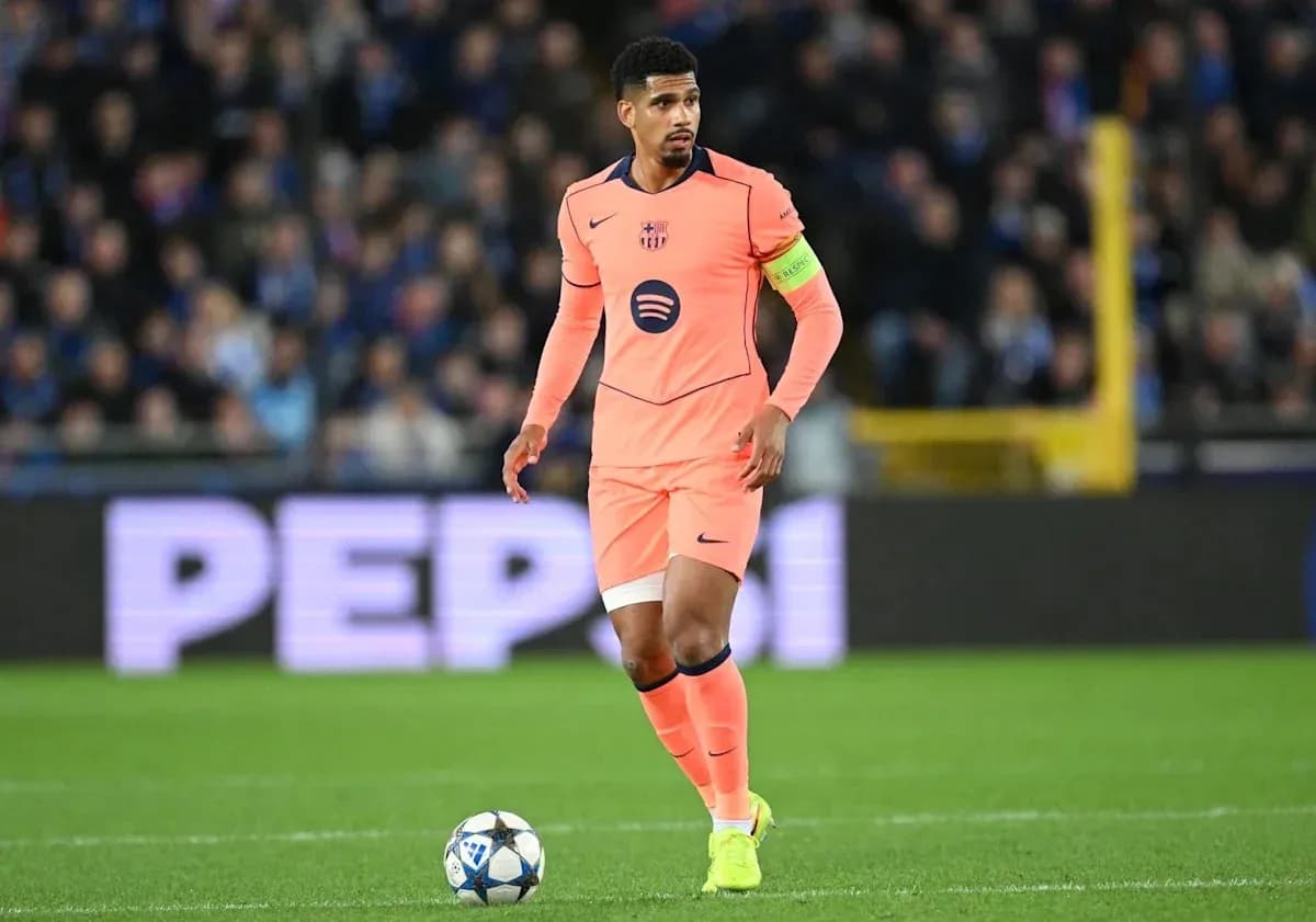 Player in pink jersey with ball on pitch