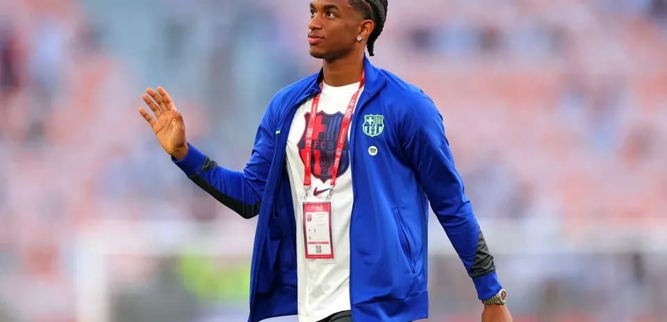 Player waving while walking in stadium before match