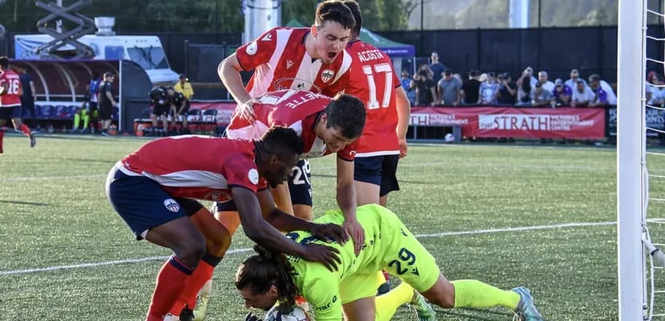Players contesting near the goal during match