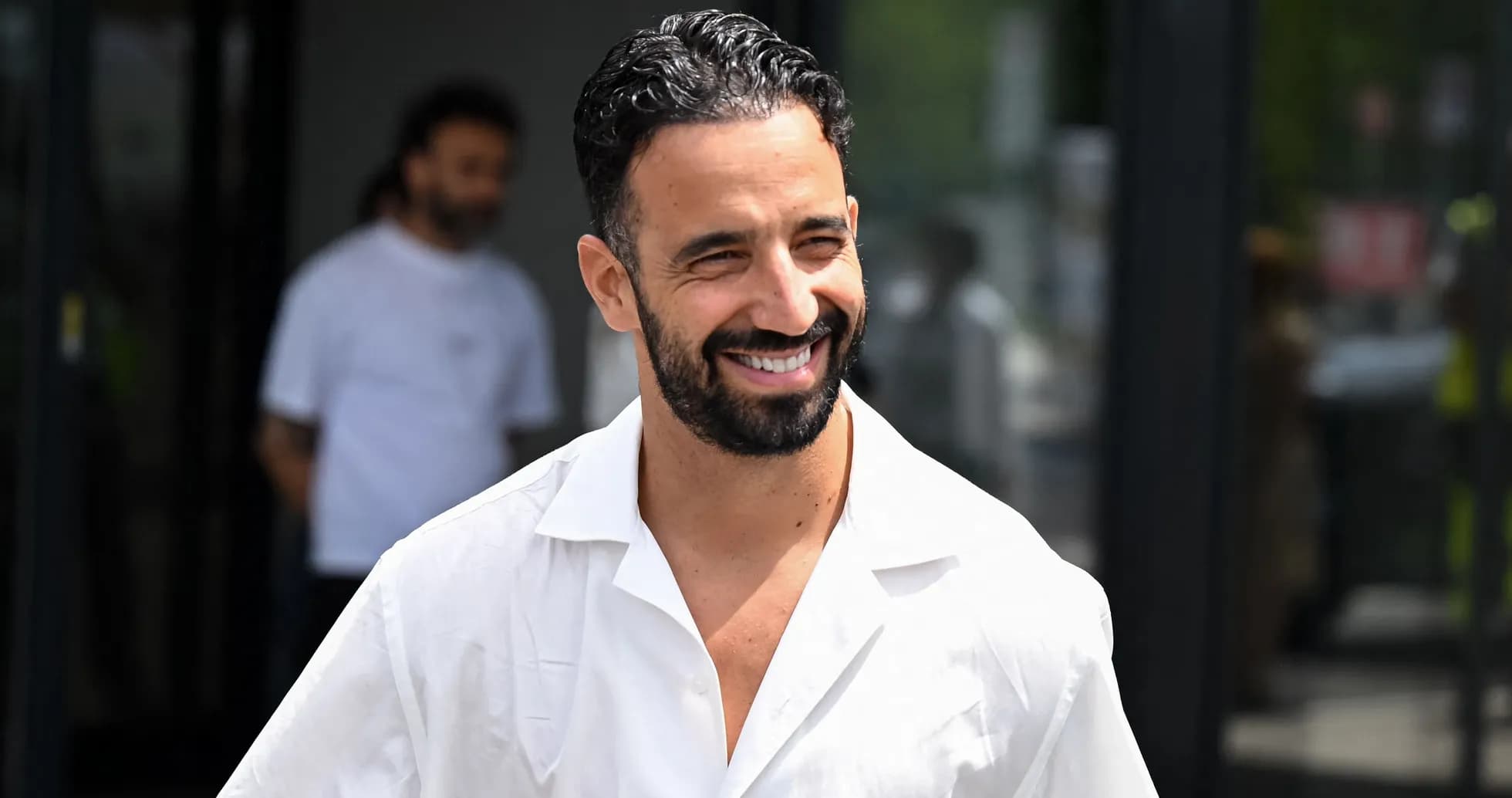 Smiling man in a white shirt outdoors