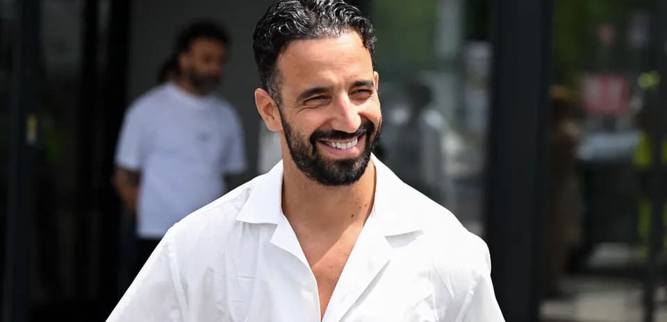 Smiling man in a white shirt outdoors