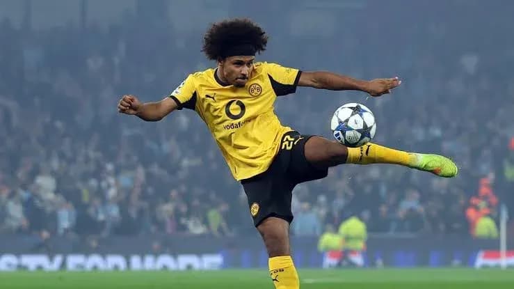 Player in yellow kit kicking a soccer ball
