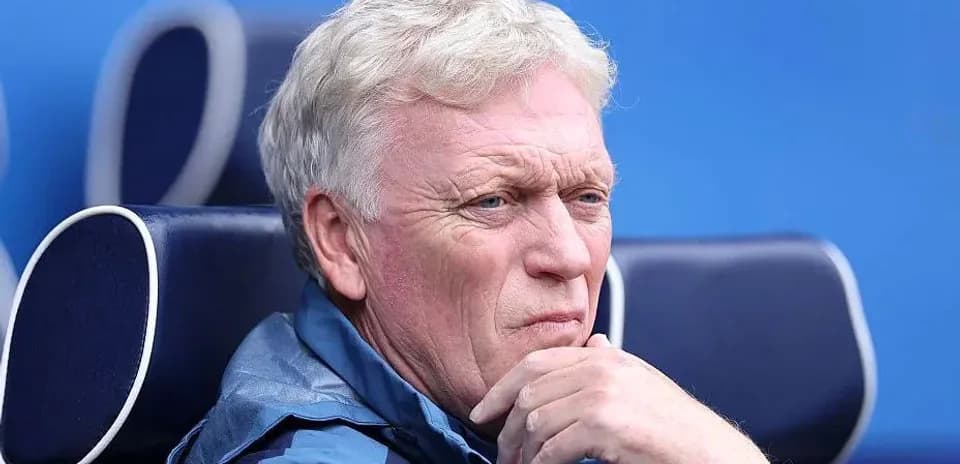Coach observing from the sidelines during match