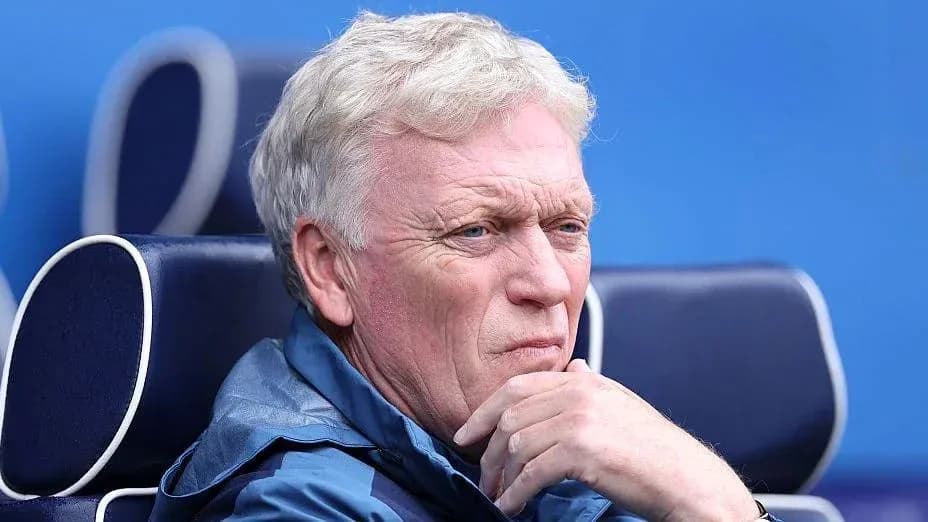 Coach observing from the sidelines during match