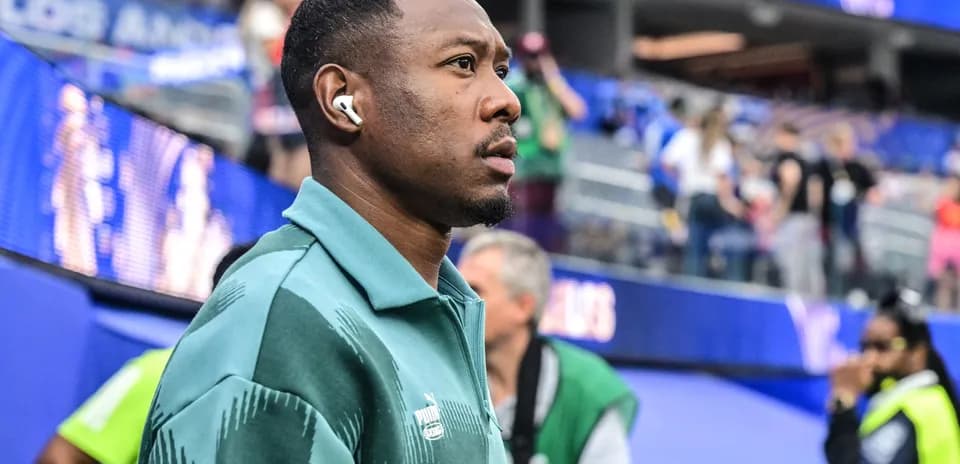 Player wearing headphones walking near stadium