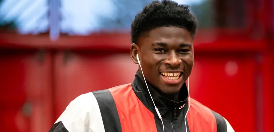 Smiling player wearing headphones in training facility