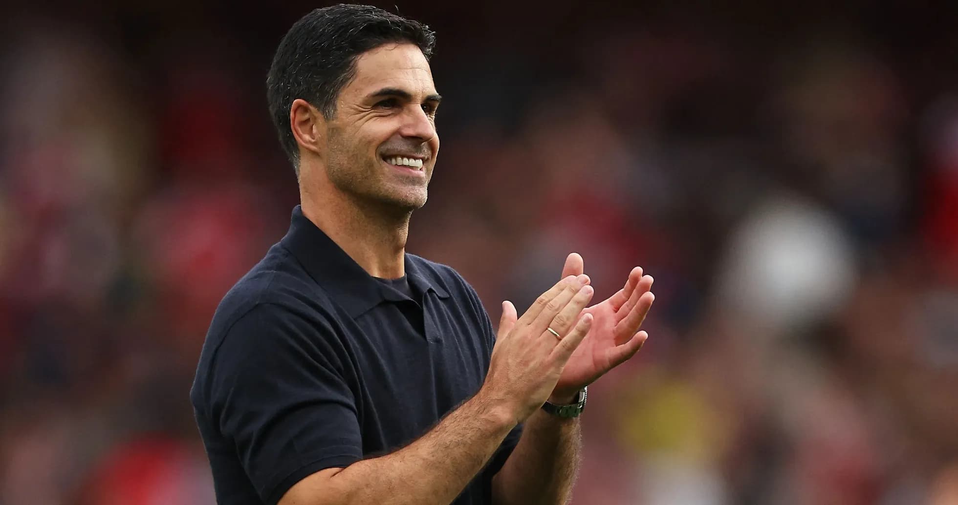 Coach clapping and smiling during match