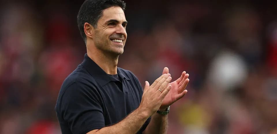Coach clapping and smiling during match