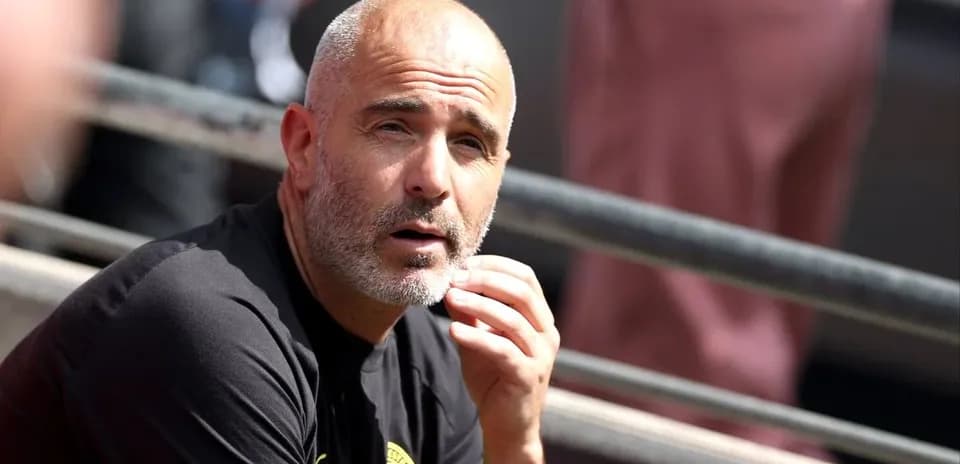 Coach sitting on the bench during a match
