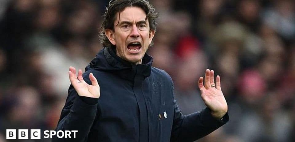 Manager gesturing during a match on the sidelines