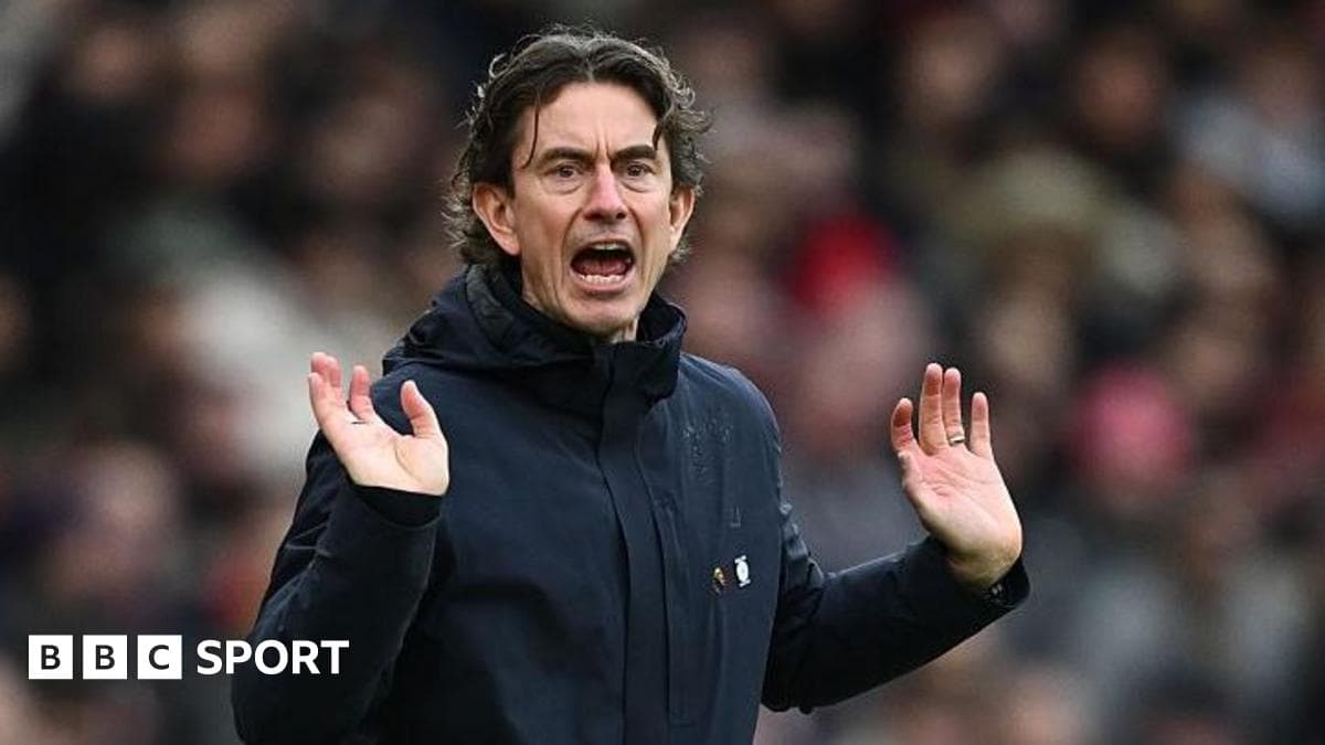 Manager gesturing during a match on the sidelines