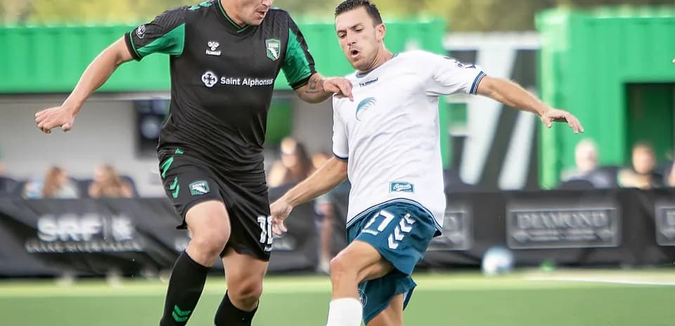 Two players competing for the ball during match
