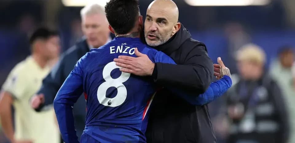 Player embracing coach after match on the field