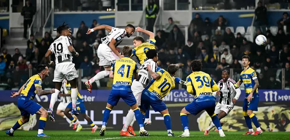 Juventus player heading the ball against Parma
