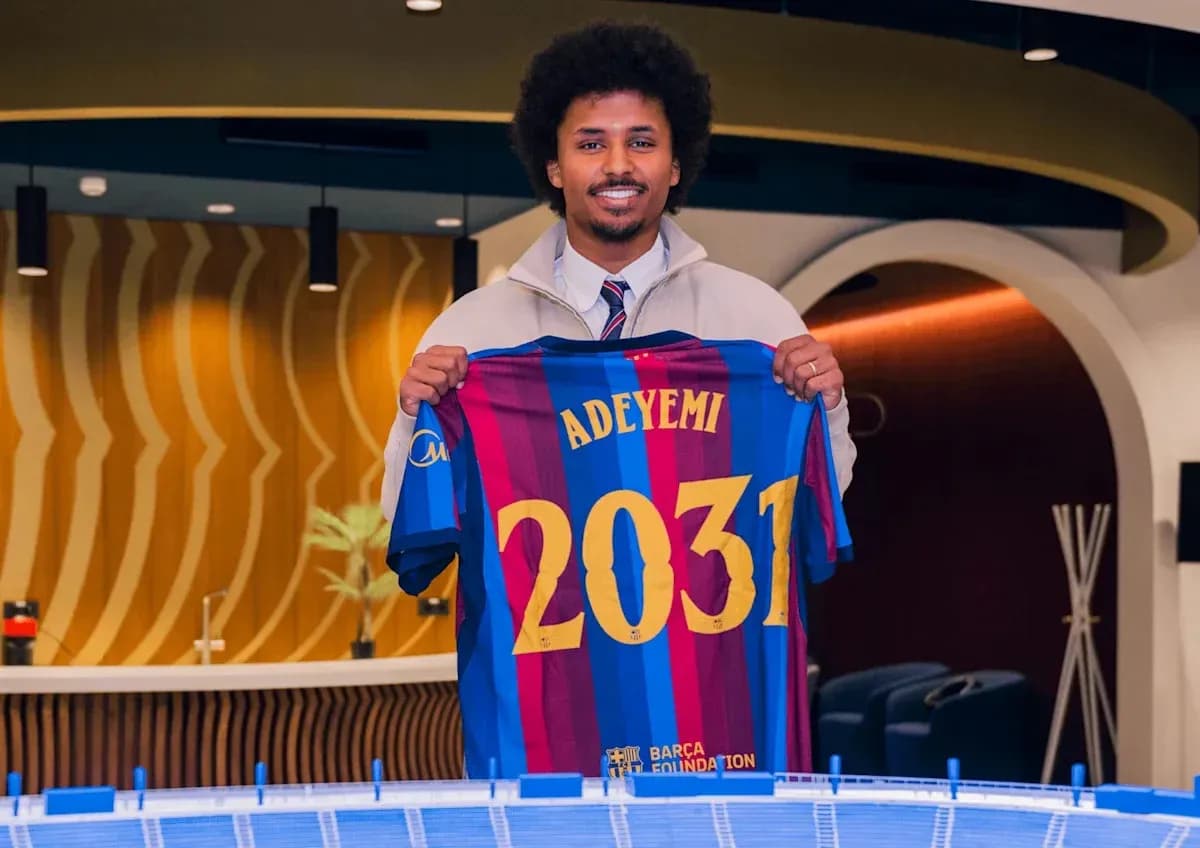 Player holding Barcelona jersey with 'ADEYEMI' and '2031'