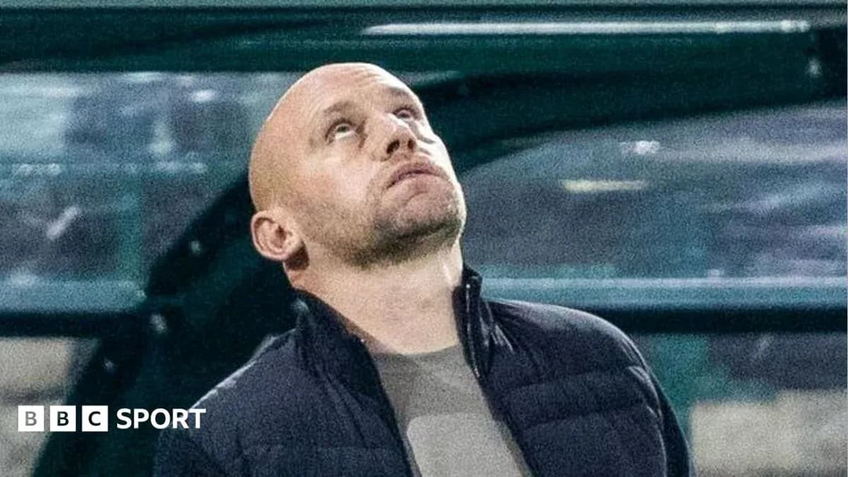 Coach looking up during match from sidelines