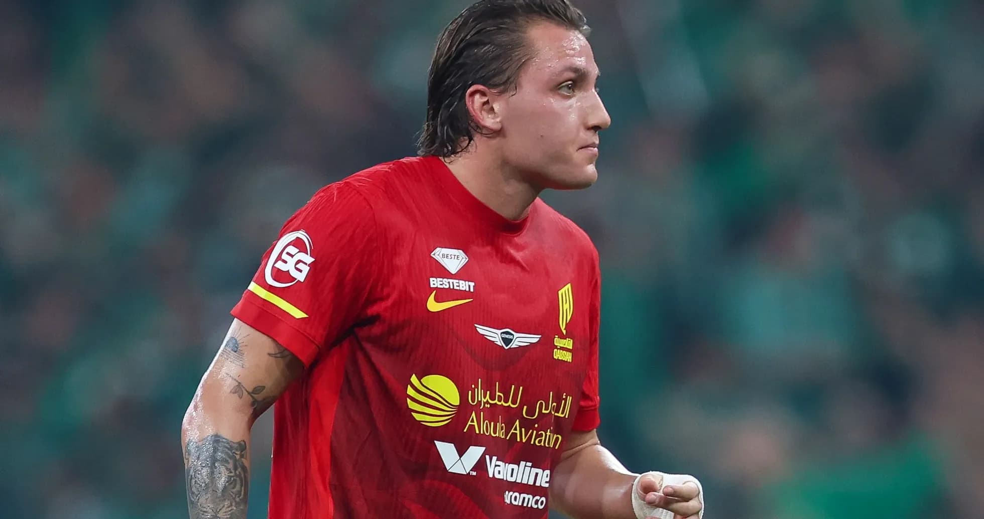 Player in red jersey running on the field