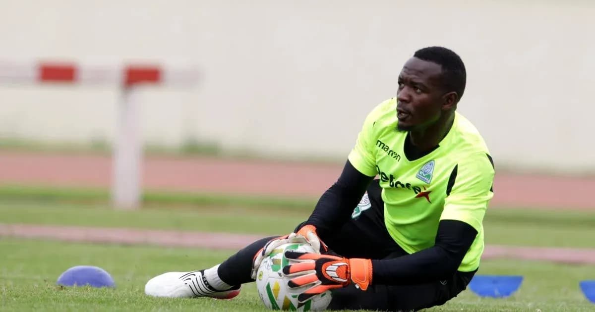 Goalkeeper training on pitch, catching a ball Goalkeeper training on pitch, catching a ball
