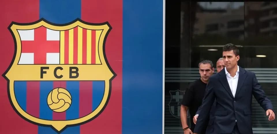 Player exiting building beside FC Barcelona logo