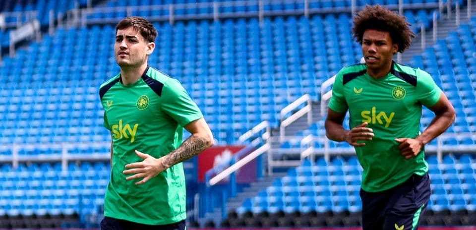 Two players jogging during training session at stadium