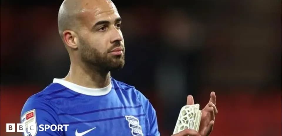 Player in Birmingham City kit applauding fans