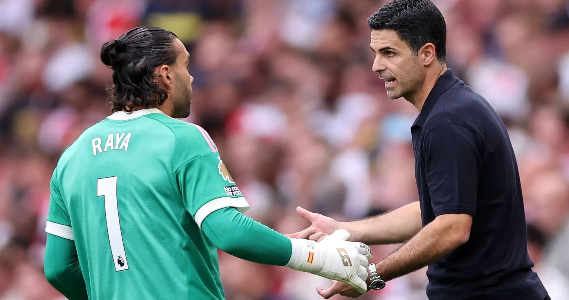 Goalkeeper Raya receiving instructions from coach