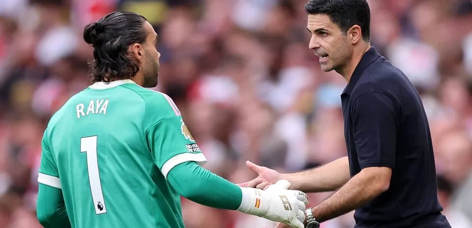 Goalkeeper Raya receiving instructions from coach