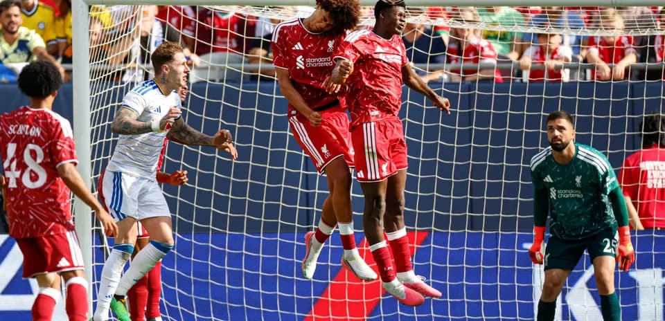 Two players heading the ball in goal area