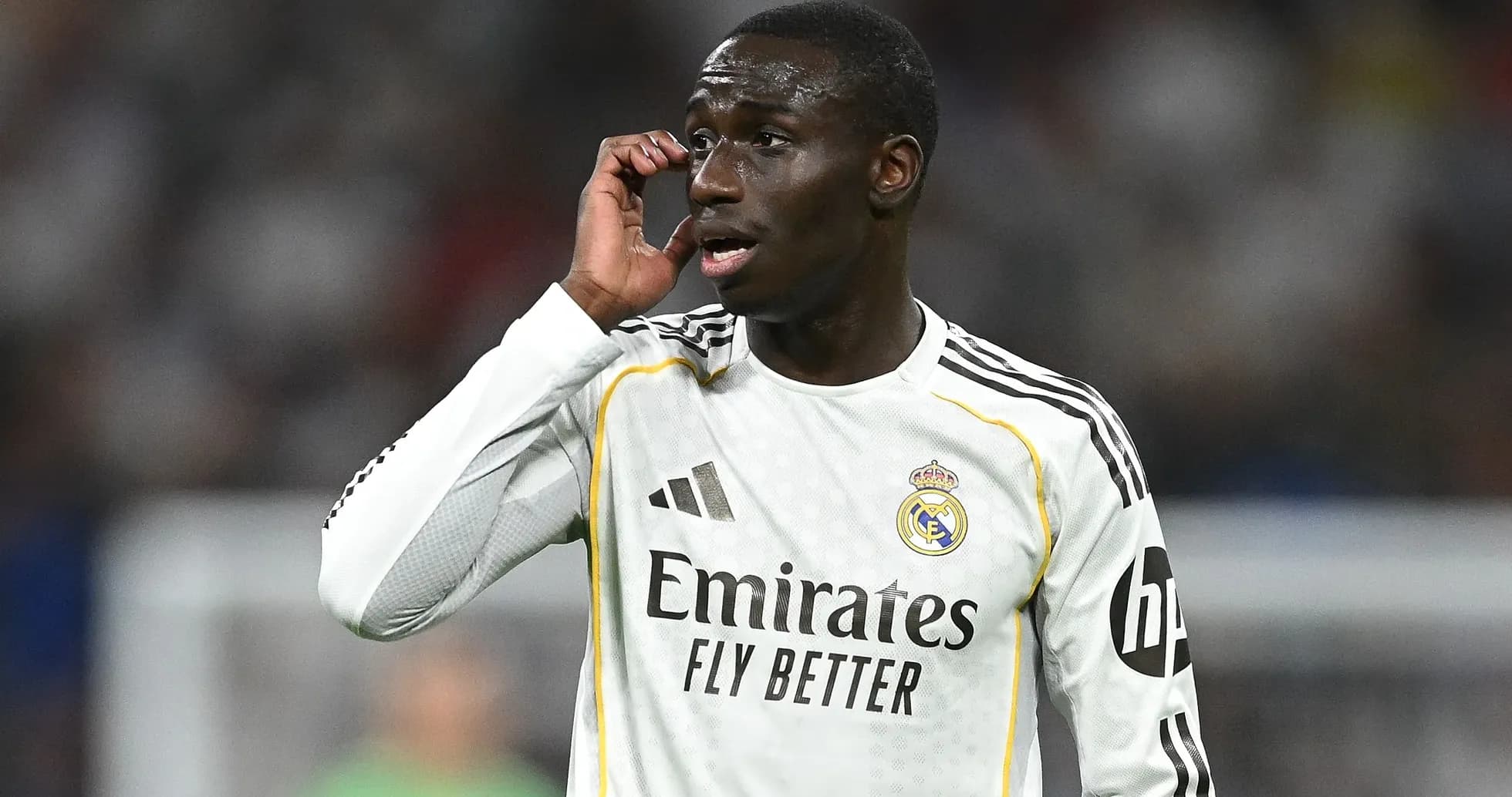 Player gesturing during match wearing Real Madrid kit