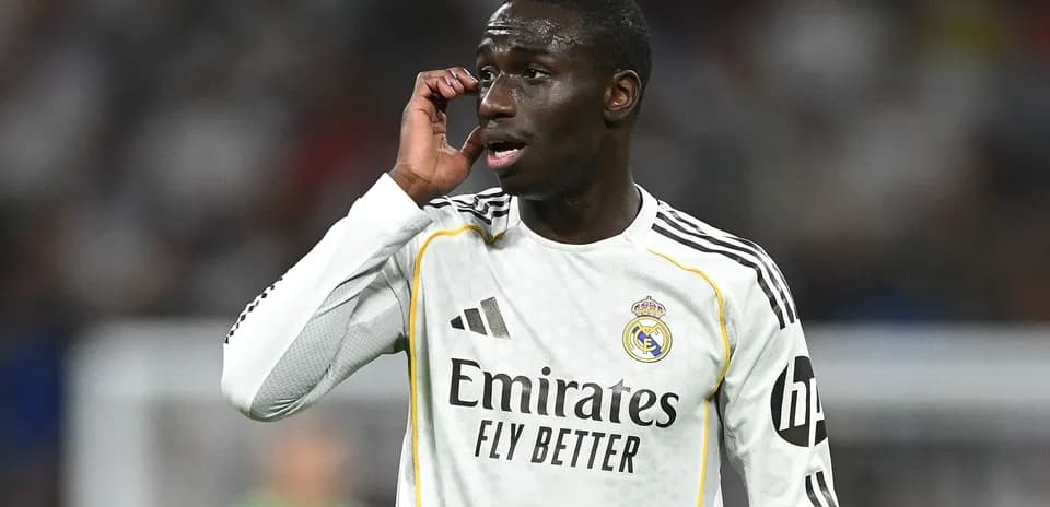 Player gesturing during match wearing Real Madrid kit