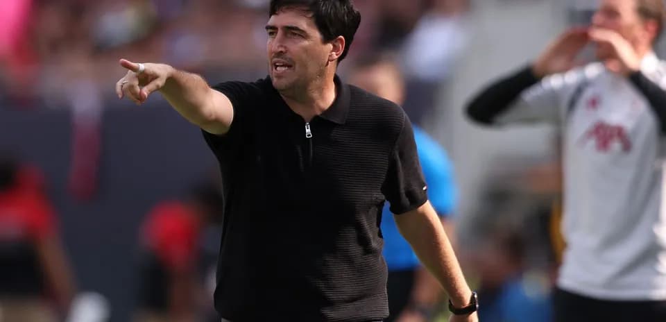Coach giving instructions on the sidelines during match